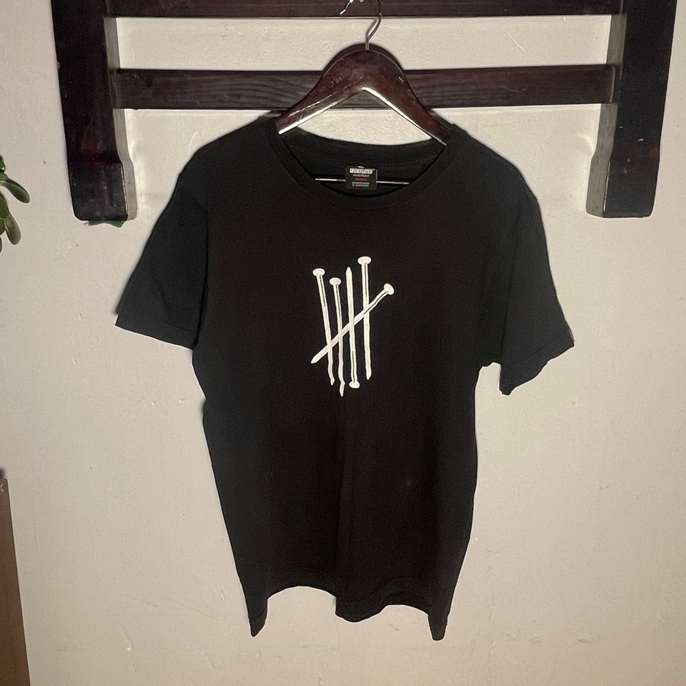 Black undefeated nail graphic tee